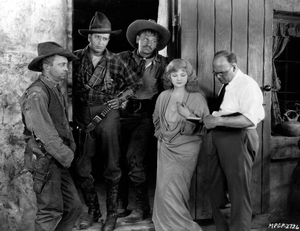 #26 Alice Terry discuss the next scene with director Reginald Barker, on the set of the MGM film ‘The Great Divide’, 1925.