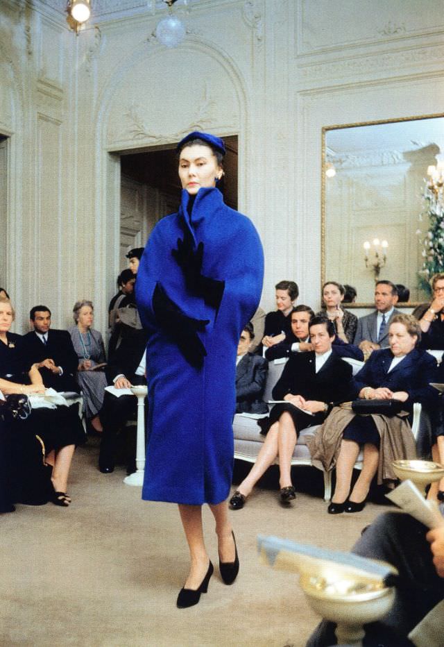 #26 Alla in blue wool version of Dior’s cape-coat, Autumn/Winter Collection H-line 1954, Maison Dior, Paris