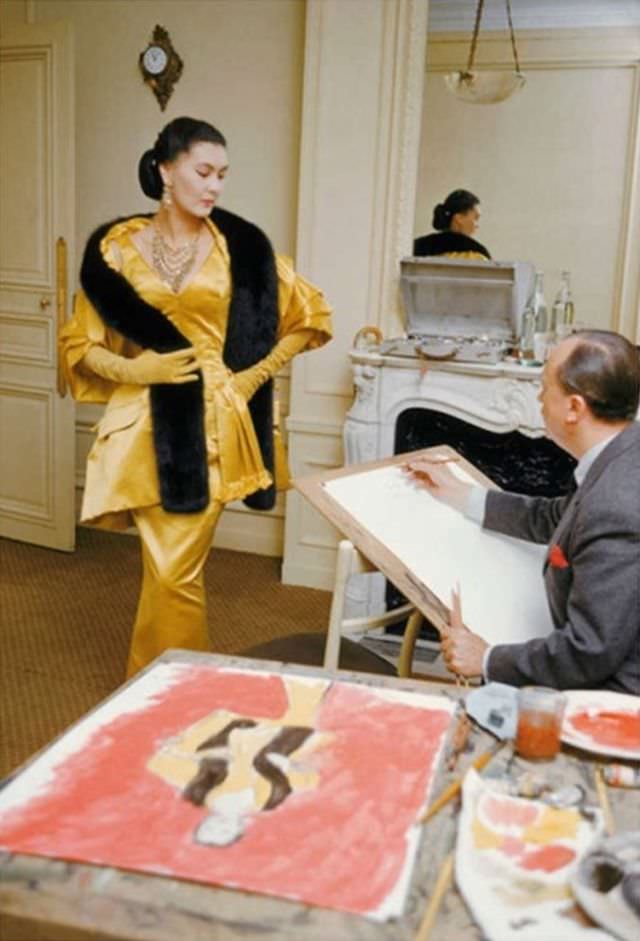 #29 Alla, decked out in Dior’s evening finery called ‘Artamène’ is being sketched by Carl Erickson, best known as Eric, for Vogue, 1954