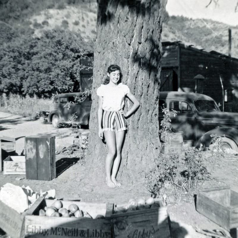 #10 Girl posing by tree and fruit boxes