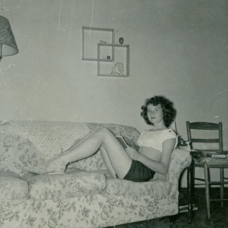 #7 Girl in shorts and crop top holding a book