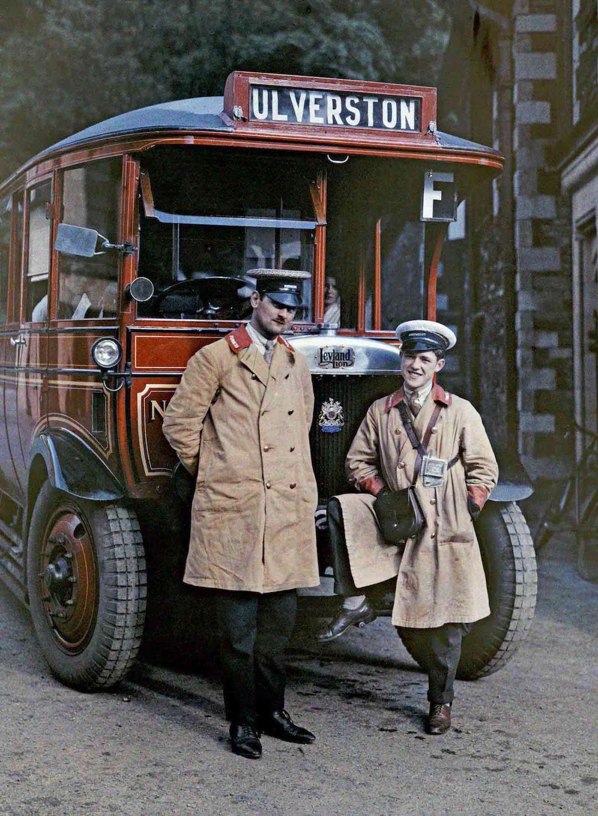 #14 Two bus drivers stand in front of a tour bus in Ulverston, Cumbria.