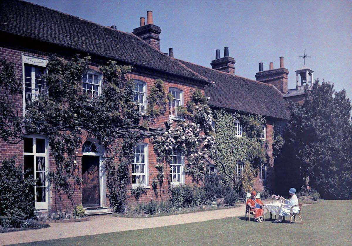 #17 Women have tea in front of the Clock House, originally a hospice, in Buckinghamshire.