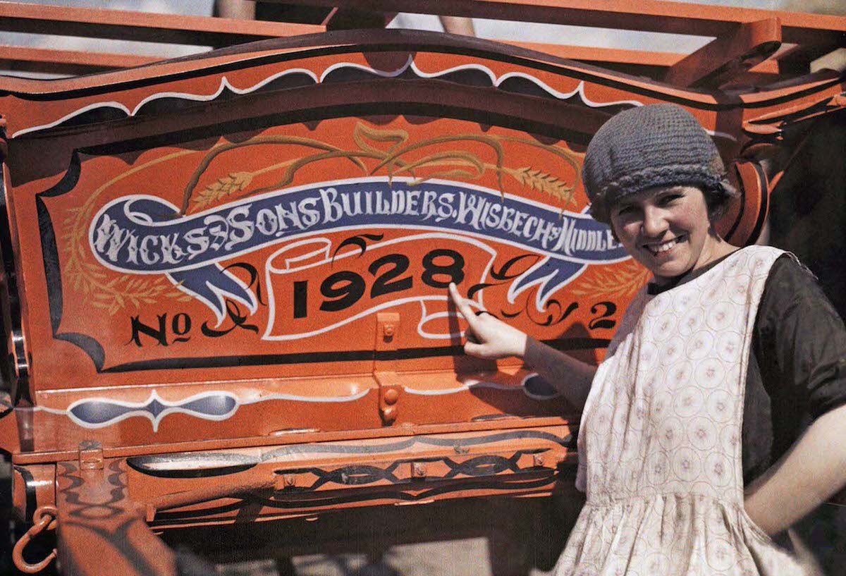 #2 An English woman points pridefully to her farm cart, in Cambridgeshire, England. Wicks of Wisbech constructed horse-drawn caravans used by Romany families traveling throughout Britain.