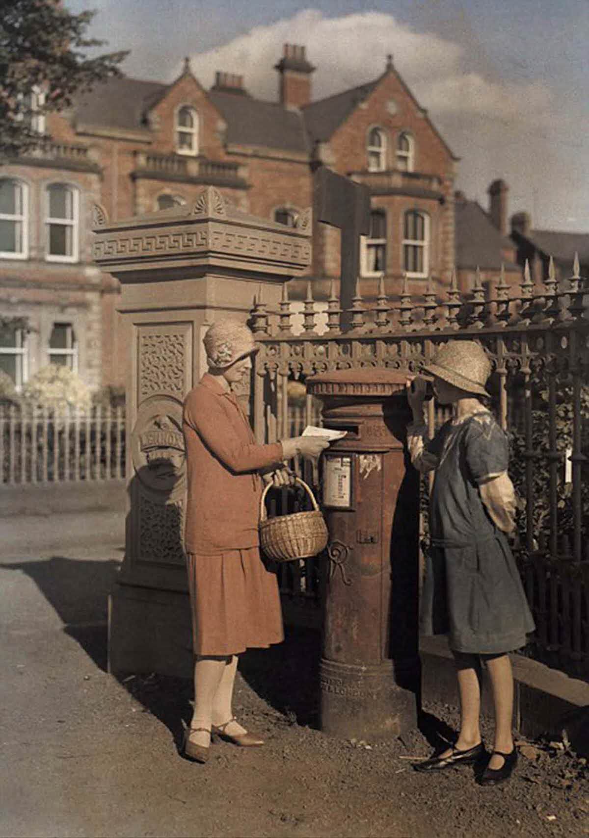 #20 Two girls send a letter at a red pillar box in Belfast in 1927.