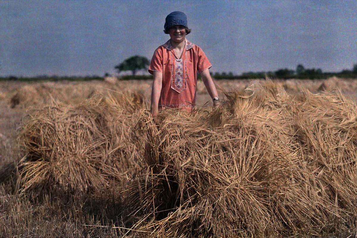 #28 A girl stands in an unidentified field in Lincolnshire in 1929 holding barley.