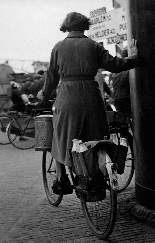 #10 Woman with groceries on a bicycle in Amsterdam, 1938.