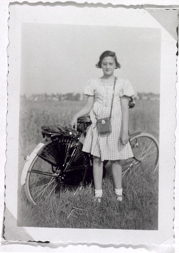 #11 Anne Frank’s sister Margot standing next to her bicycle in Amsterdam, 1938.