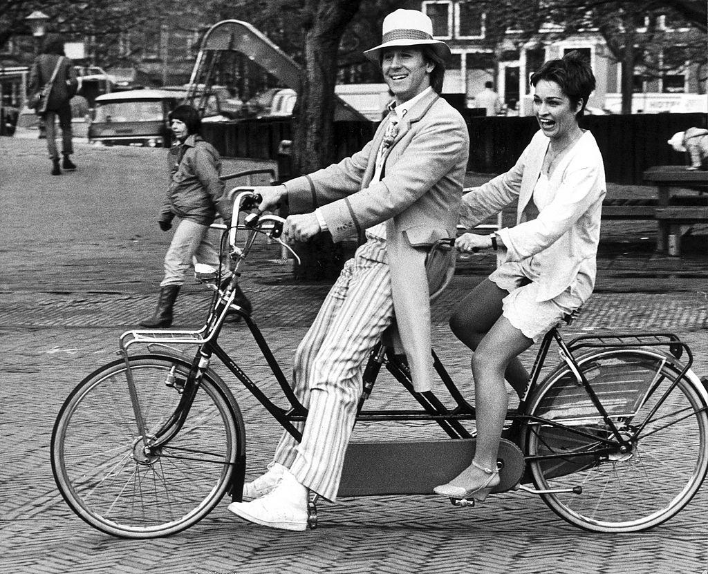 #26 Peter Davison and Janet Fielding riding round Amsterdam, 1982.