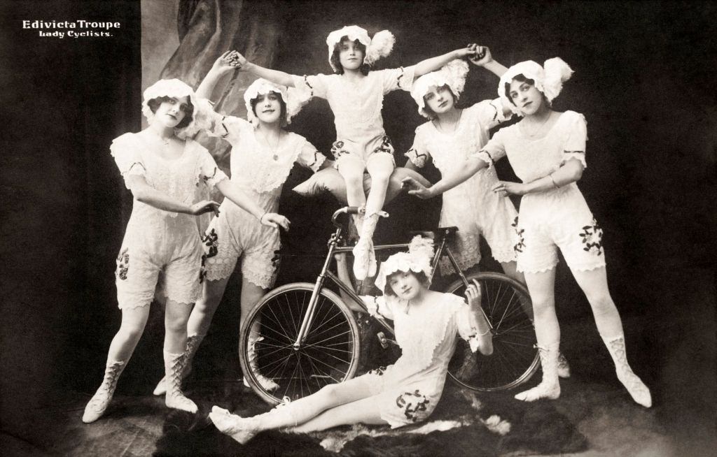 #6 A vintage postcard featuring a troupe of performing lady cyclists posing in their costumes, Amsterdam, 1920s.