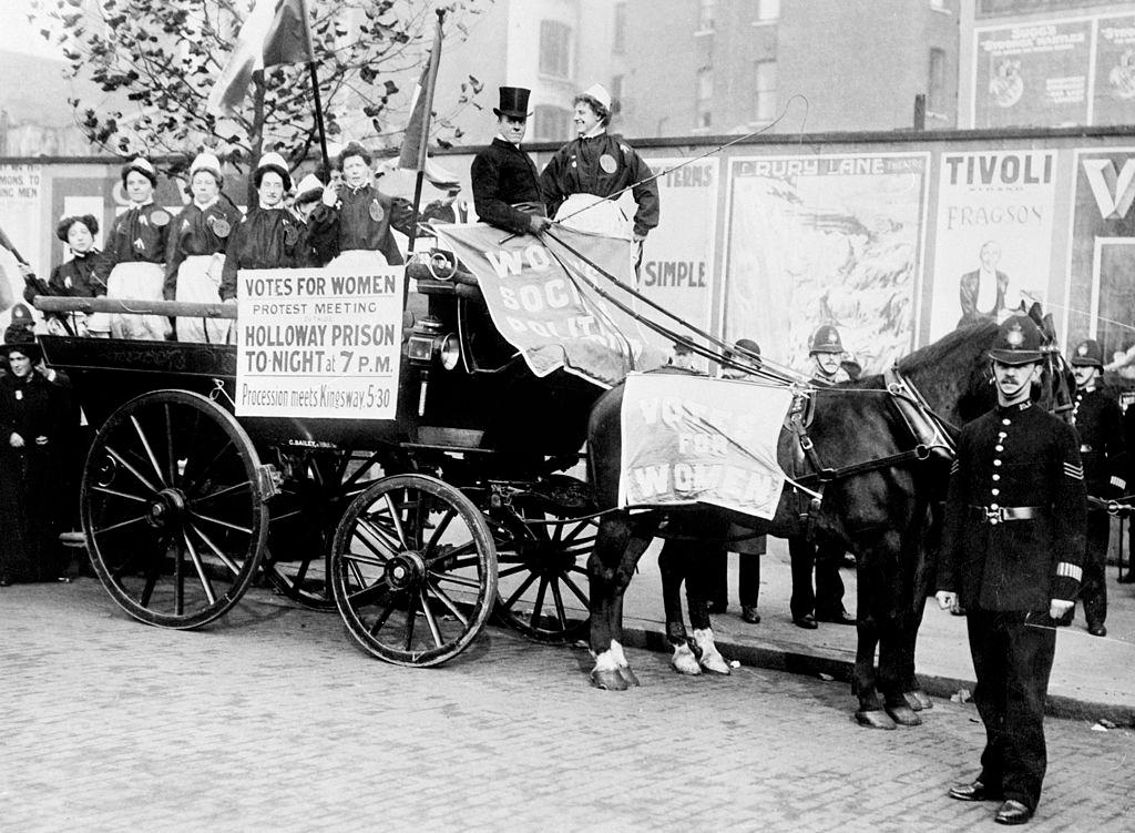 #26 Ex-suffragette prisoners, wearing replica prison clothing, advertise a ‘protest meeting’ to be held outside Holloway Gaol, 7th November 1908.