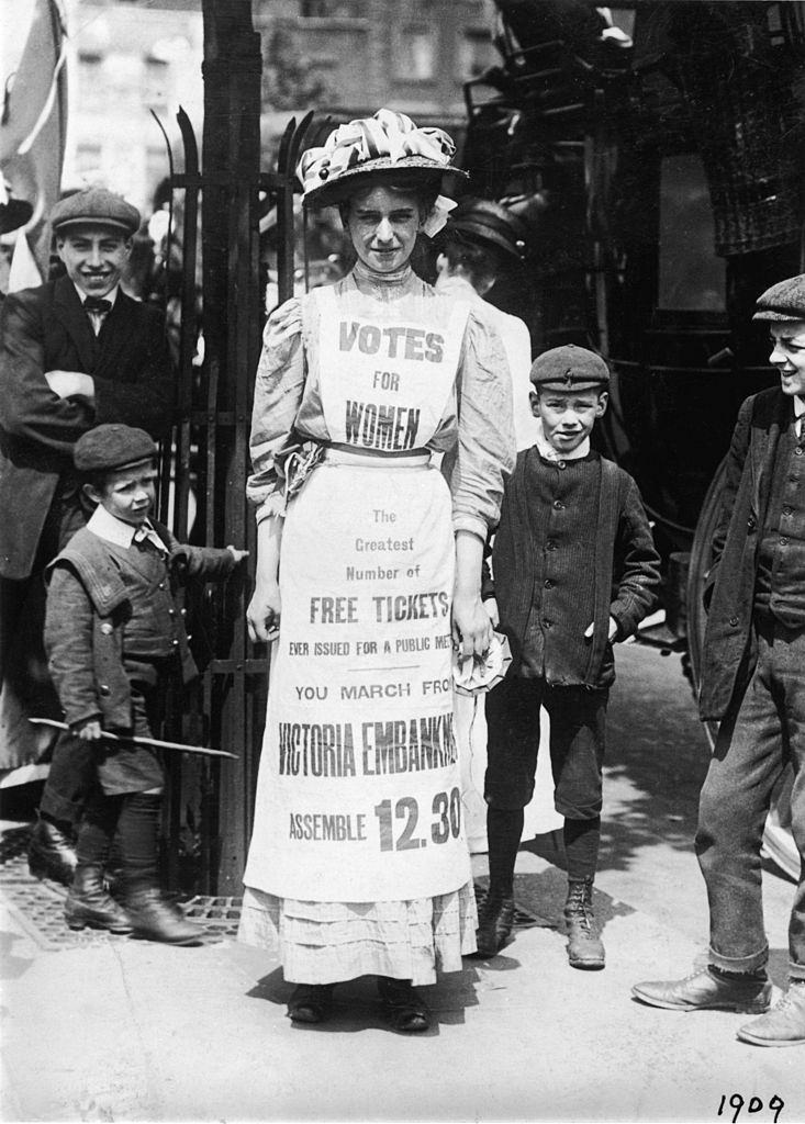 #35 Suffragette advertising a march supporting votes for women, Strand, London, 1909.
