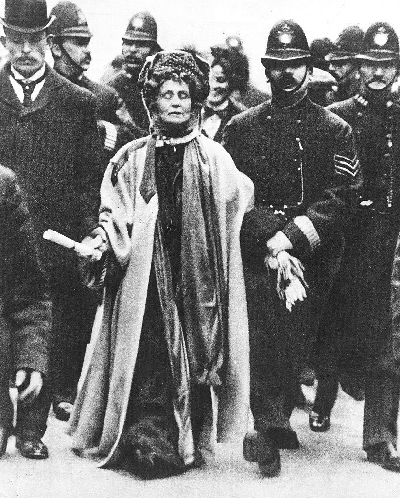#44 Emmeline Pankhurst at her eleventh arrest is taken by the police officer, 1911.