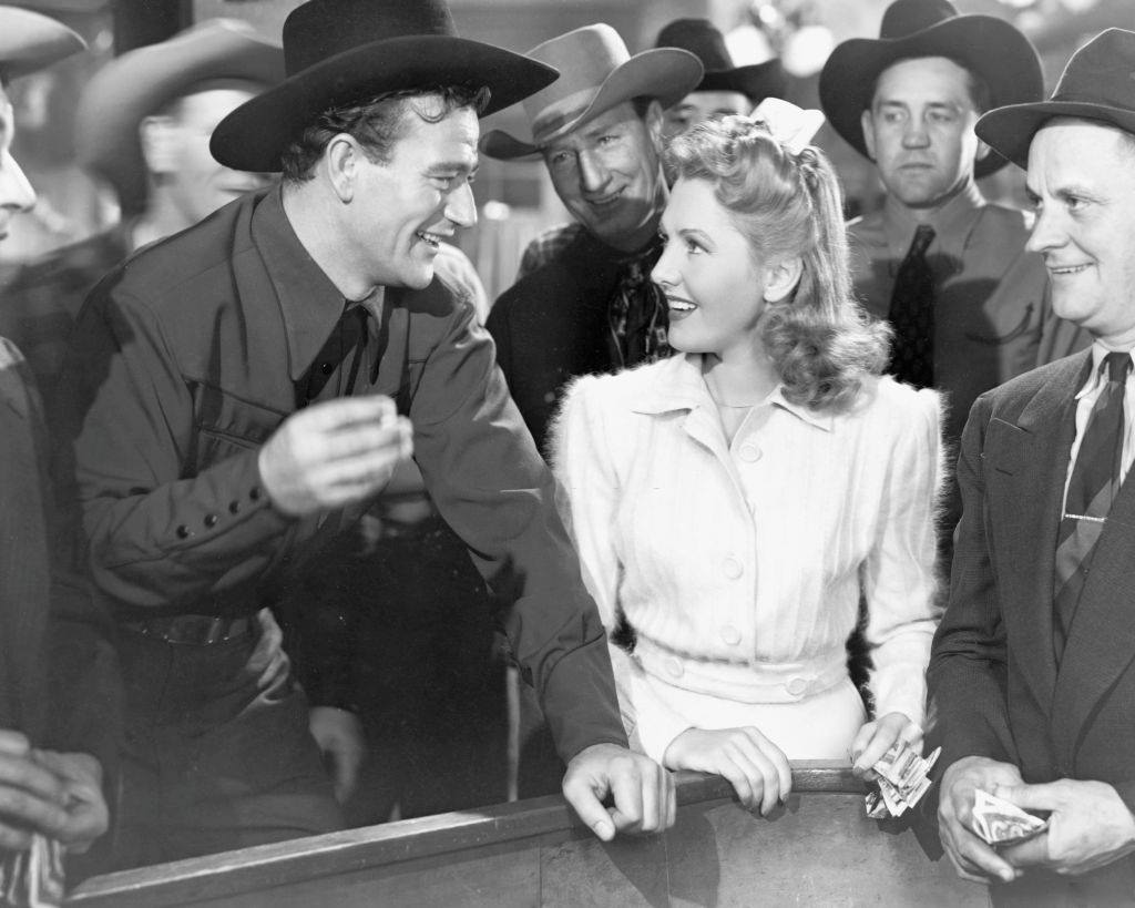 #43 Jean Arthur as Molly J. Truesdale and John Wayne as Duke Hudkins in the romantic comedy ‘A Lady Takes a Chance’, 1943.