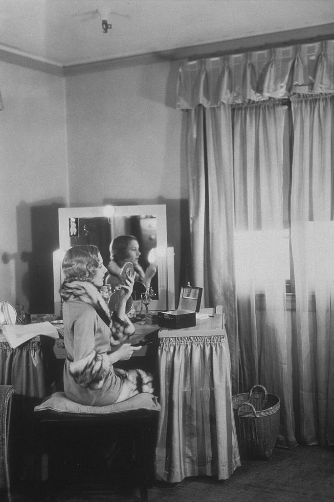 #61 Jean Arthur at her dressing table during a break from filming ‘The Gang Buster’, 1931.
