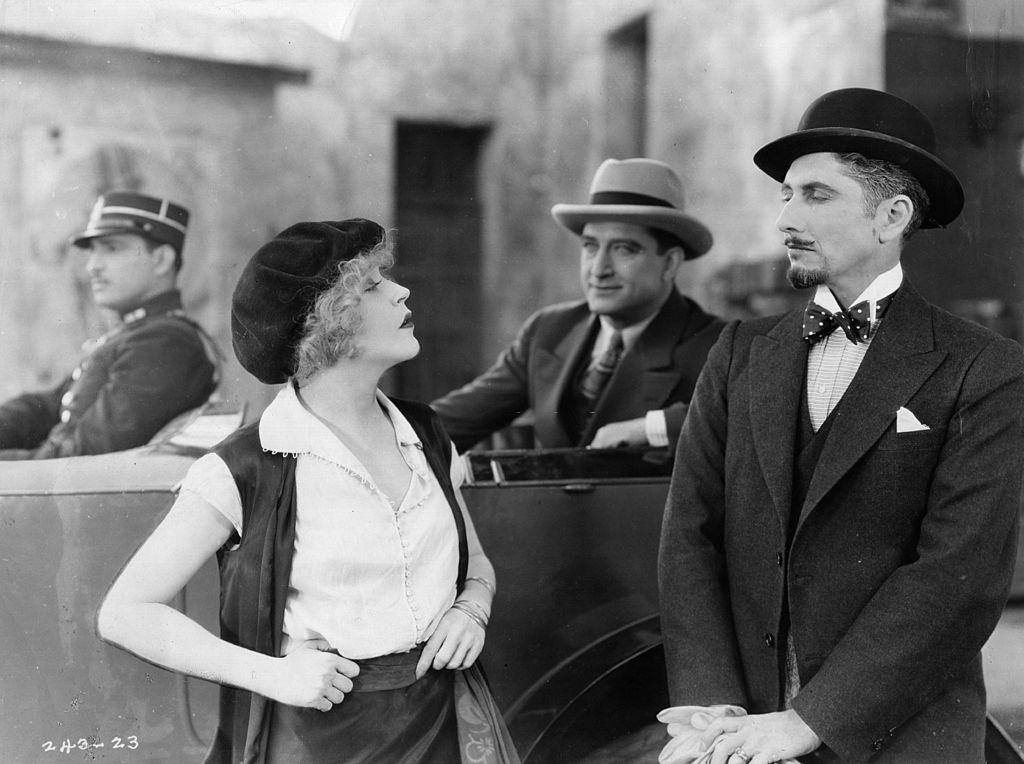 #4 Mae Murray with Marie Adrienne Koenig in a scene from ‘Masked Bride’, 1920.