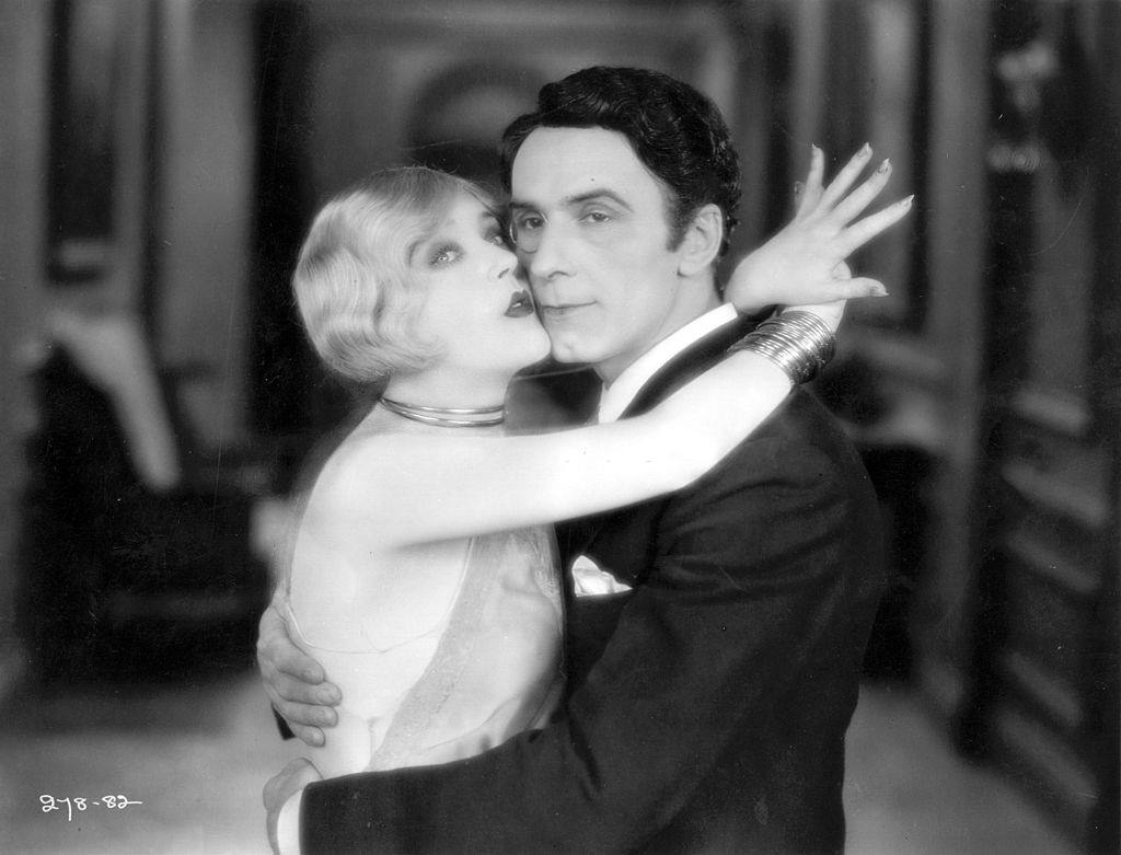 #47 Mae Murray with George Andre Beranger in a scene from the film ‘Altars Of Desire’, 1927.