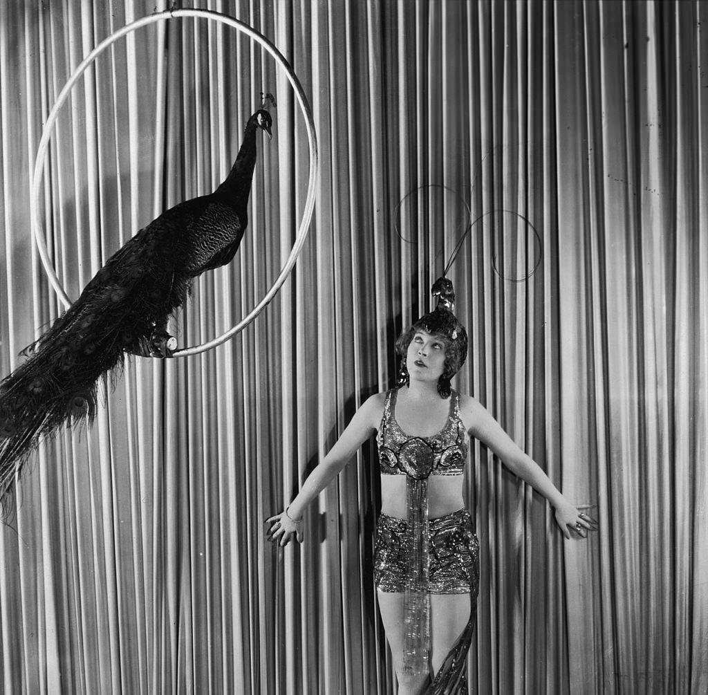 #8 Mae Murray in peacock costume and headdress as Cleo of Paris in ‘Peacock Alley’, 1922.