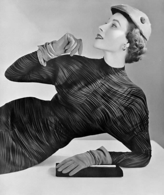 #12 Myrtle Crawford in black and brown print dress by Carven, cap by Claude St. Cyr, 1953