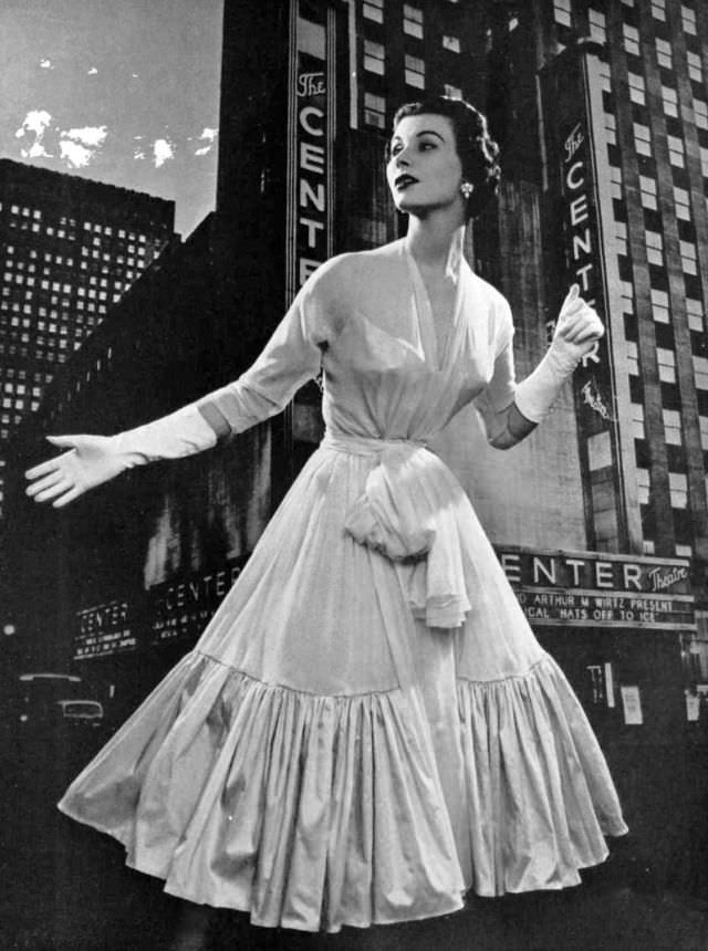 #13 Myrtle Crawford in dress made for dancing, pale pink chiffon bordered by ruffle of pink taffeta, by Lanvin-Castillo, 1953