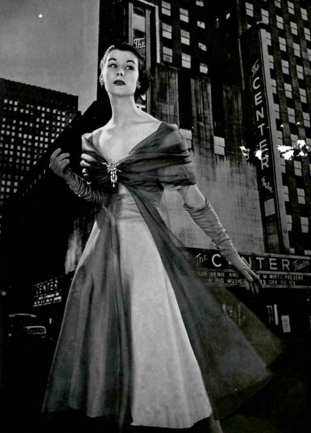 #16 Myrtle Crawford in evening dress by Grès, brooch by Roger Scèmama, 1953