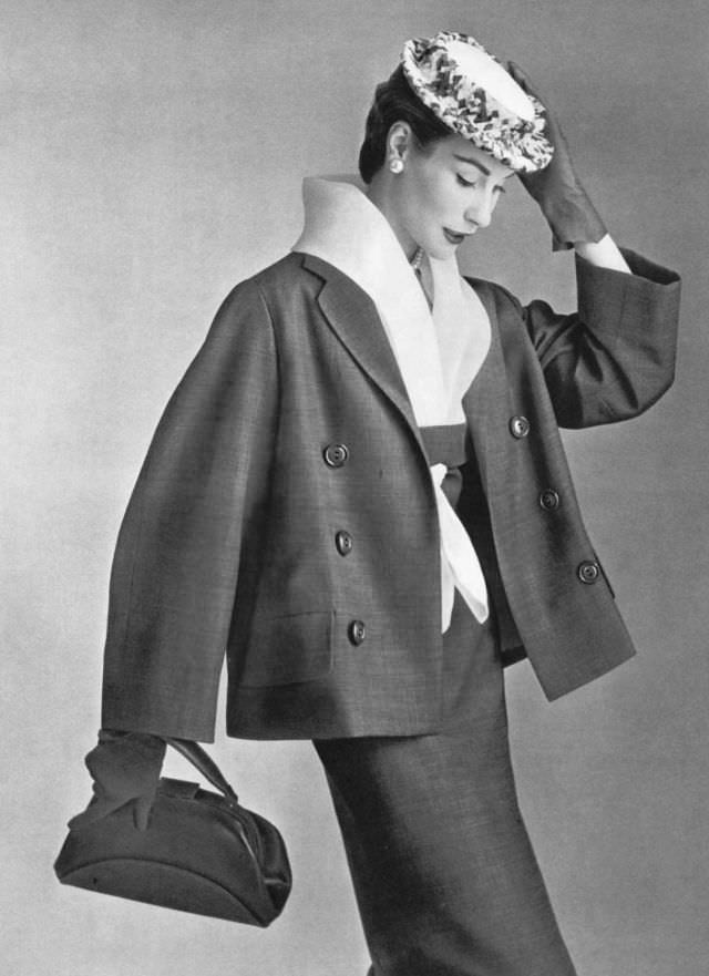 #36 Myrtle Crawford in dress with white organdy fichu collar worn under roomy jacket, by Lanvin-Castillo, 1954