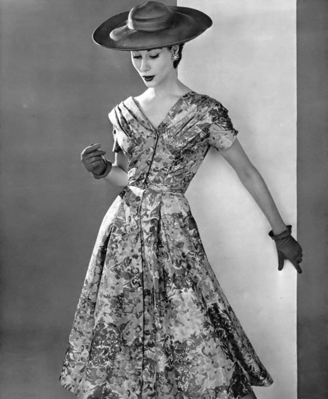 #42 Myrtle Crawford in silk floral print of grays and pinks, perfect for a garden party, by Jean Dessès, 1954.