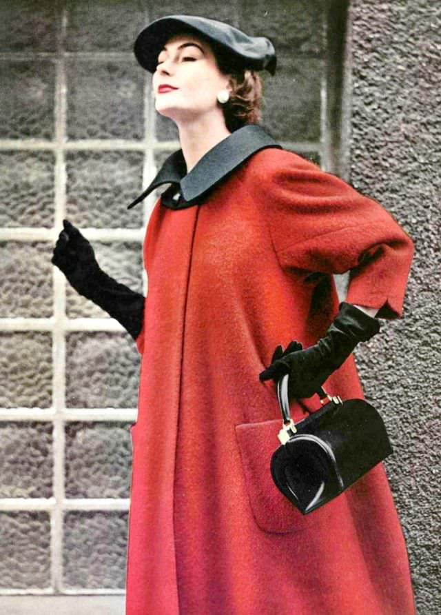 #13 Anne Gunning in red wool coat with black collar, single button closure, black gros-grain beret, by Manguin, handbag by Roger Model, 1953