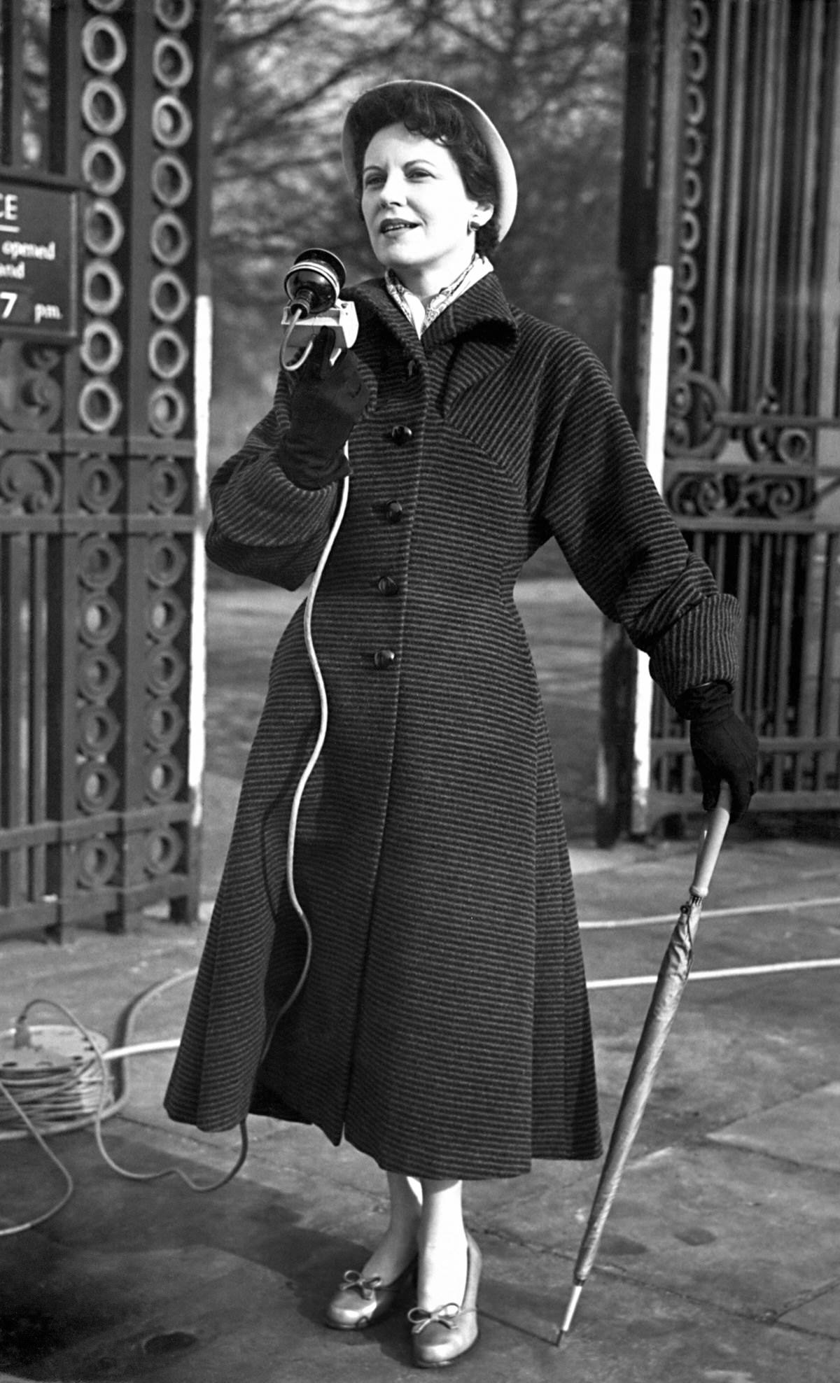 #18 Microphone and umbrella in hand, Manchester born broadcaster Jessica Dunning makes an outside broadcast in an audition for commentators for the Coronation.
