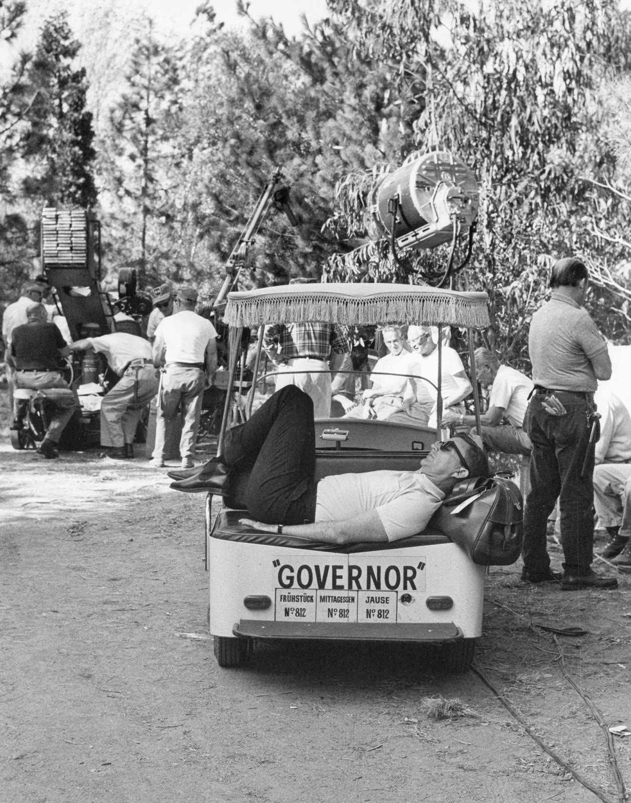 #26 Director Blake Edwards grabs a nap in a golf cart on location in Salzburg, Germany, for “The Great Race,” 1964