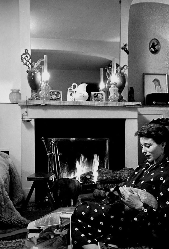 #10 Bettina in her Paris apartment with her two Siamese cats, 1952