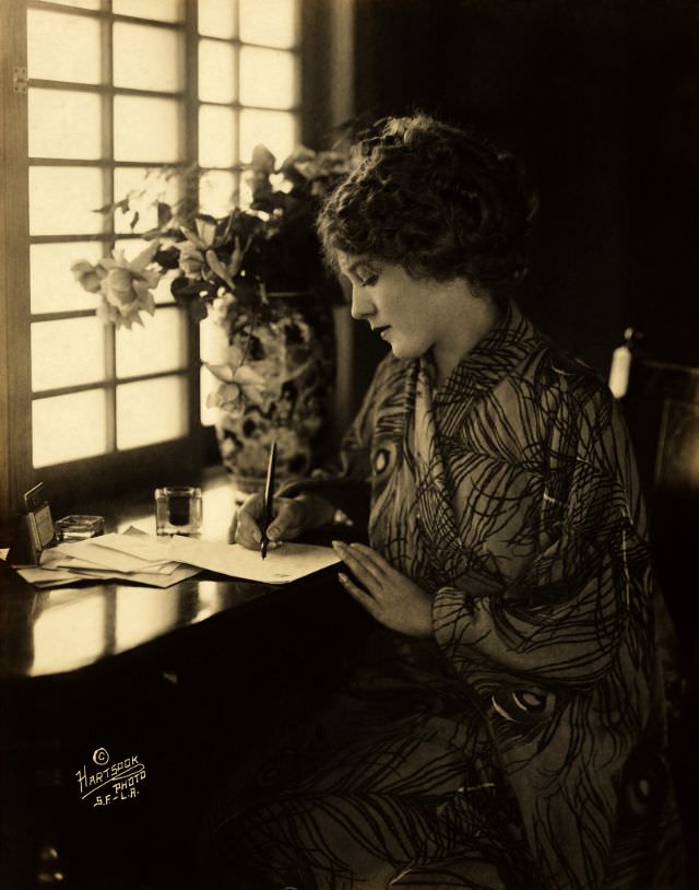 #34 Mary Pickford, wearing a kimono, writing at a desk, 1918