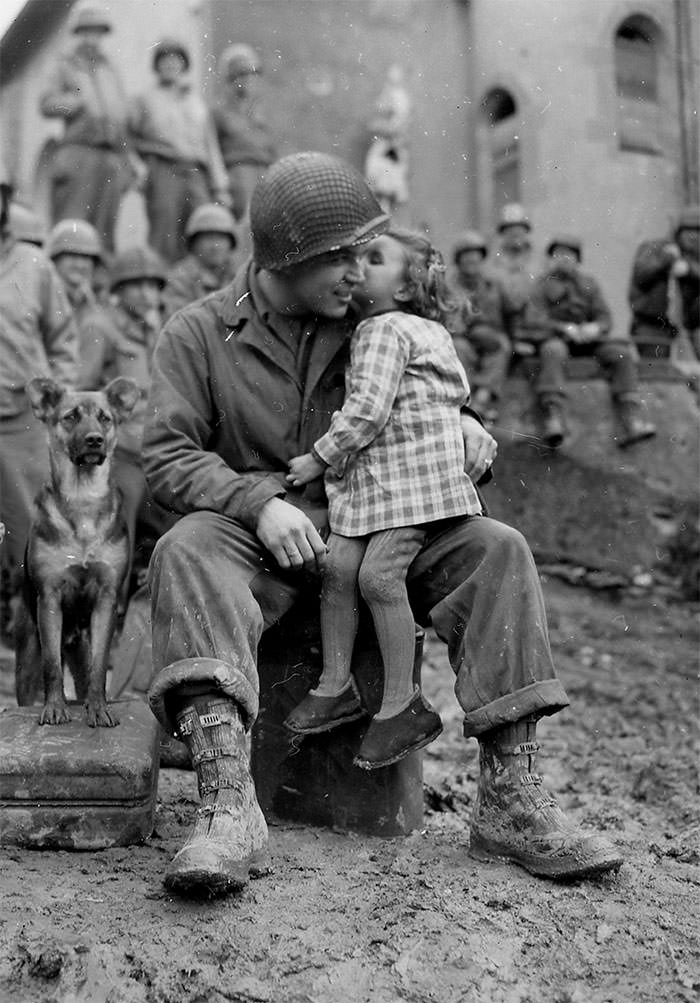 #22 A little french girl gives an american soldier a kiss on valentine’s day, 1945