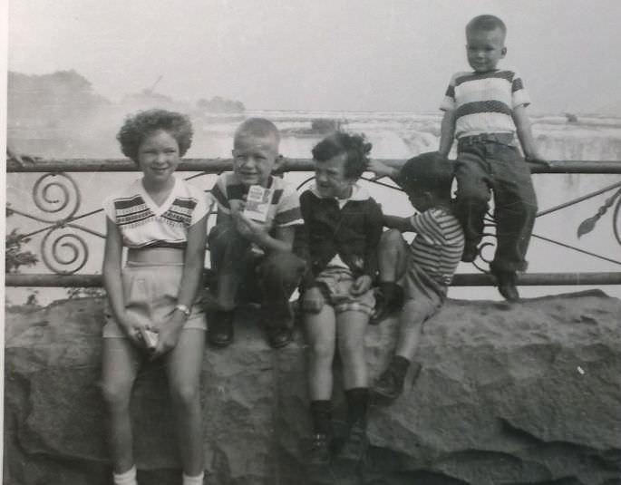 #61 Me, sitting on the rail at niagra falls in 1956.