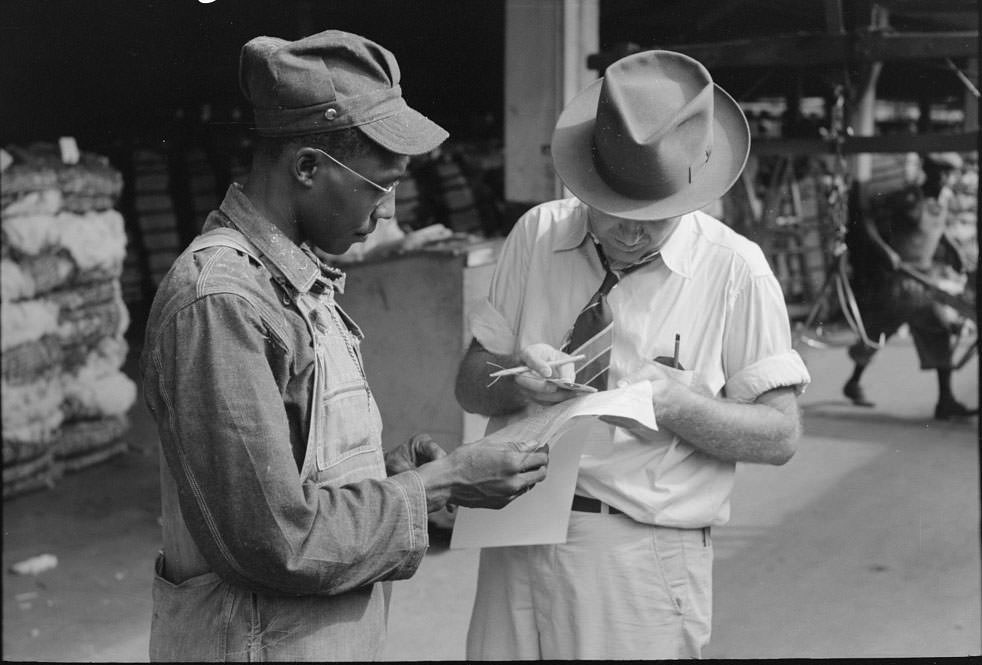 #9 Trucker and weighing checker at unloading platform. Cotton compress, Houston, Texas