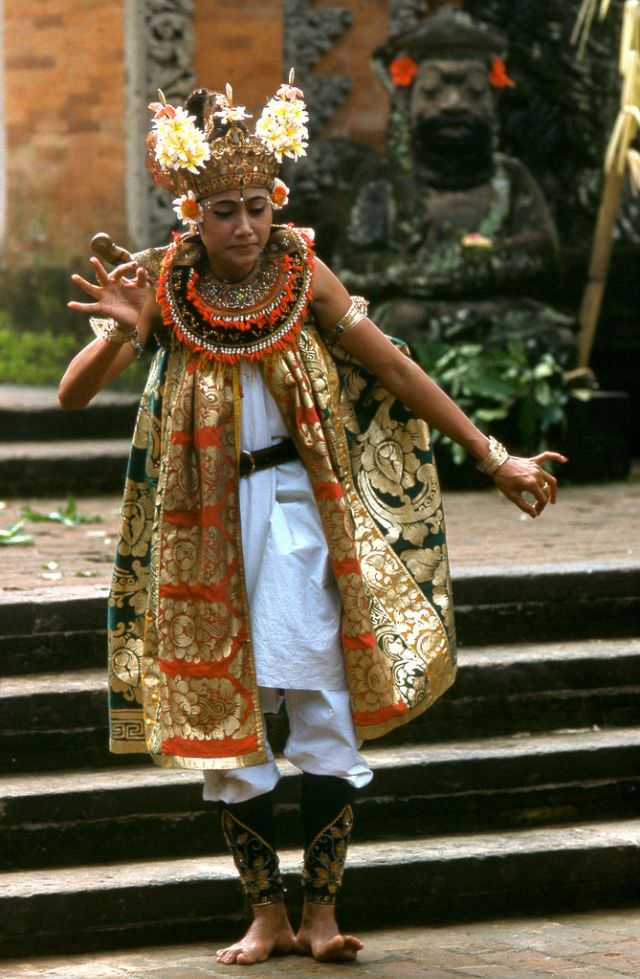 #67 Colorful costume worn by a dancer performing a traditional dance at Kuta Beach, 1970s