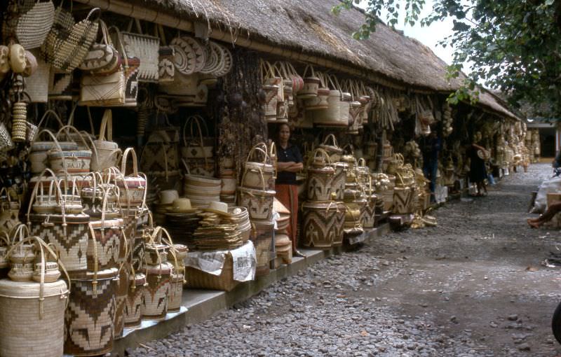 #73 Vendor and baskets on a sidestreet at Kuta Beach, Bali, 1970s