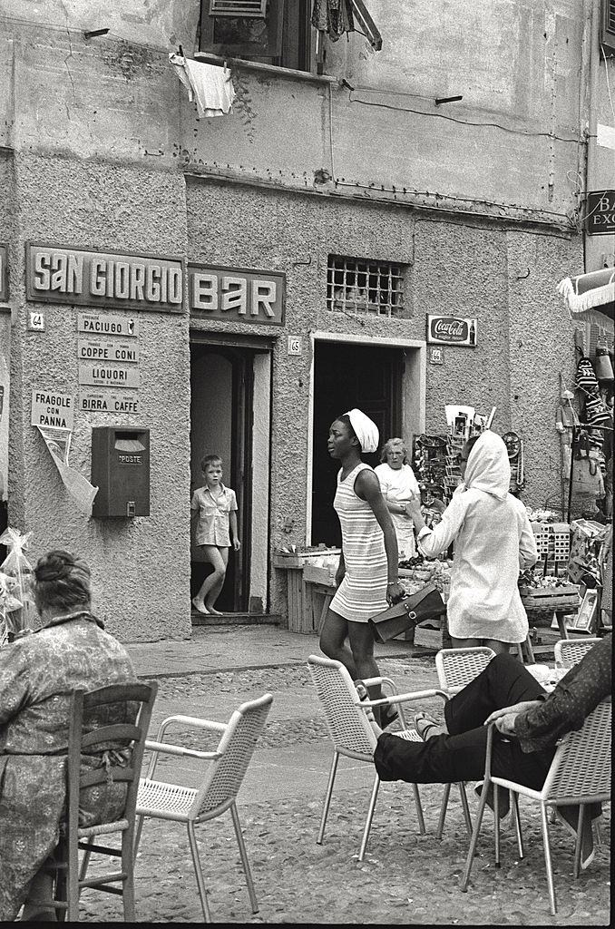 #74 An African girl walking in Portofino, 1960s.