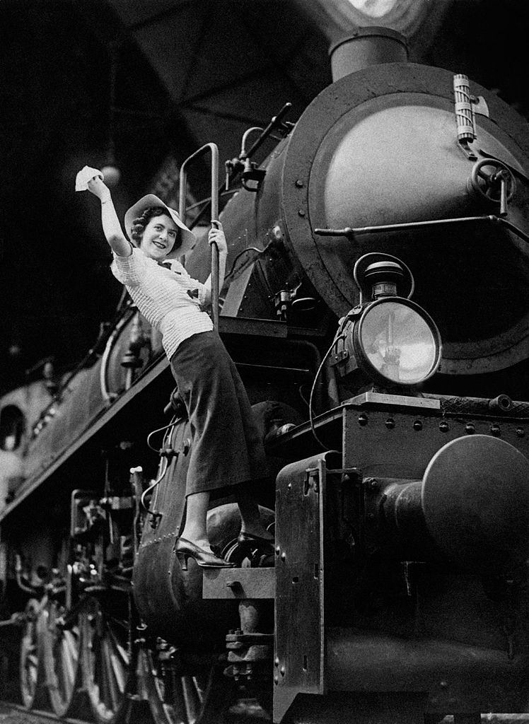 #4 Young woman greeting from a locomotive waving her handkerchief, 1960s.