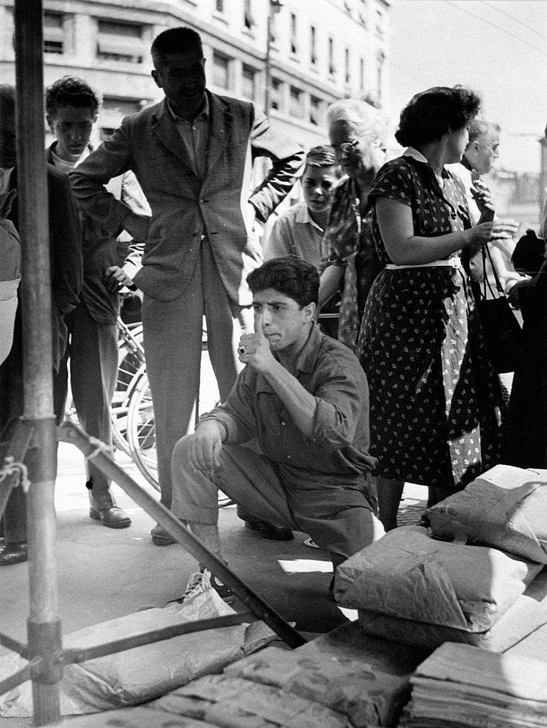 #95 A pedlar selling items at a market, Italy, 1960s