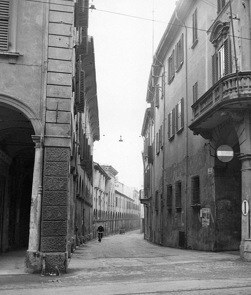 #97 A man riding a bicycle along a street of Bologna., 1960s.
