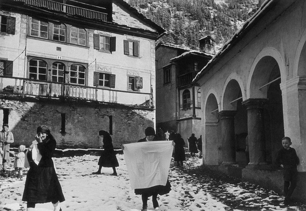 #3 The inhabitants of Carcoforo walking in a square of the village, Carcoforo, 1960s.