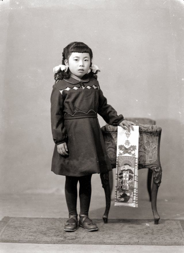 #1 A girl in braids, a dress, and flats holding Chitose Ame Shichi-Go-San candy