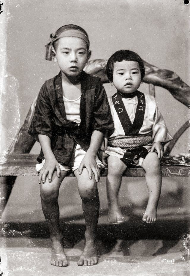 #2 A Japanese boy and Japanese girl in traditional happi coats (he is wearing a headband as well)