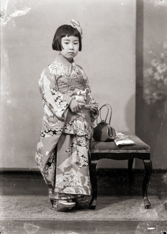 #21 A young Japanese girl in a kimono with a handbag and hair bow