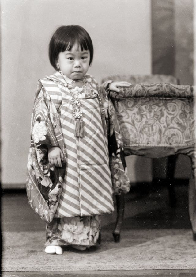 #28 A young Japanese girl posing for a portrait in a kimono