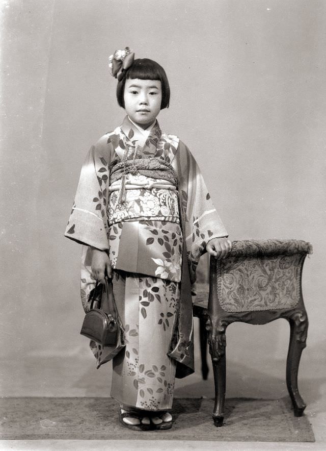 #29 A young Japanese girl wearing a kimono and holding a handbag