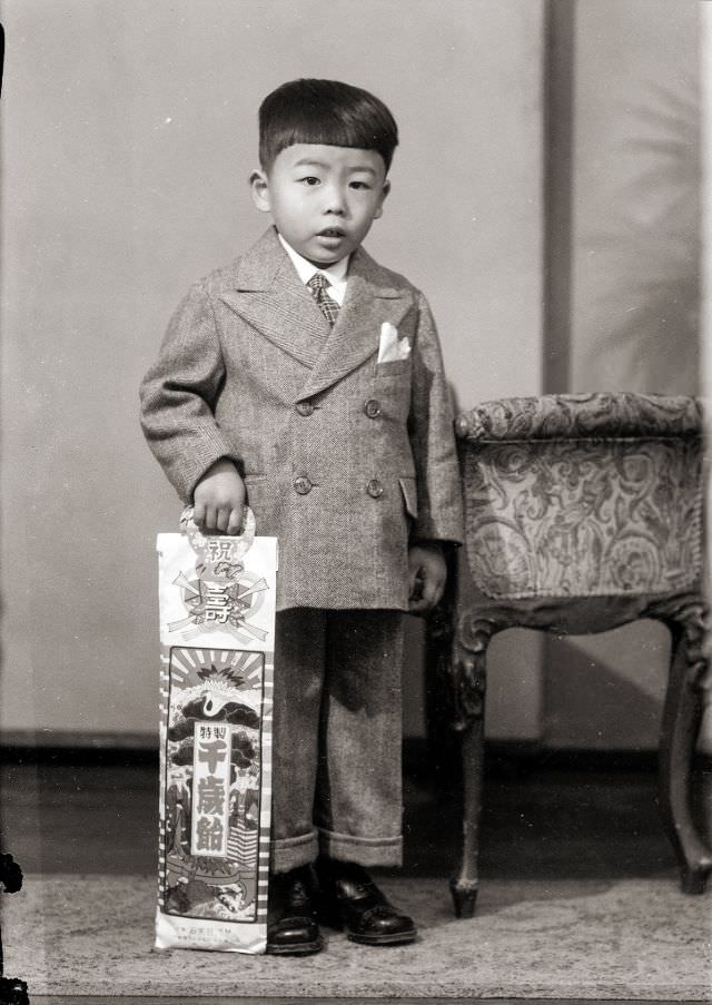 #4 A Japanese boy in a suit with traditional Shichi-Go-San (seven-five-three) candy