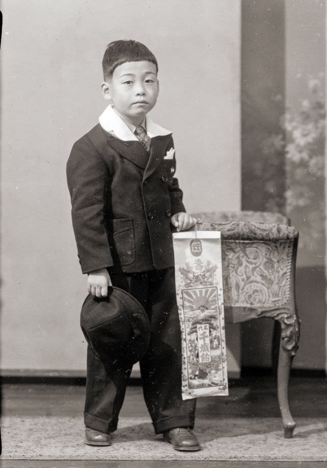 #7 A Japanese boy posing for a portrait with traditional Chitose Ame candy for Shichi-Go-San holiday