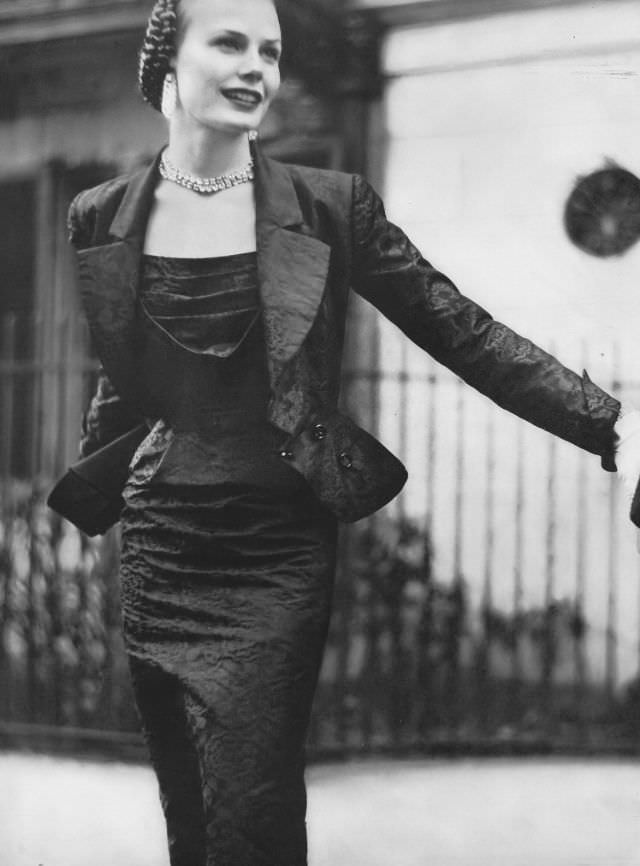 #1 Lillian Marcuson in beautifully cut and shaped dress and jacket of silk brocade taffeta by Adele Simpson, Vogue, July 1950